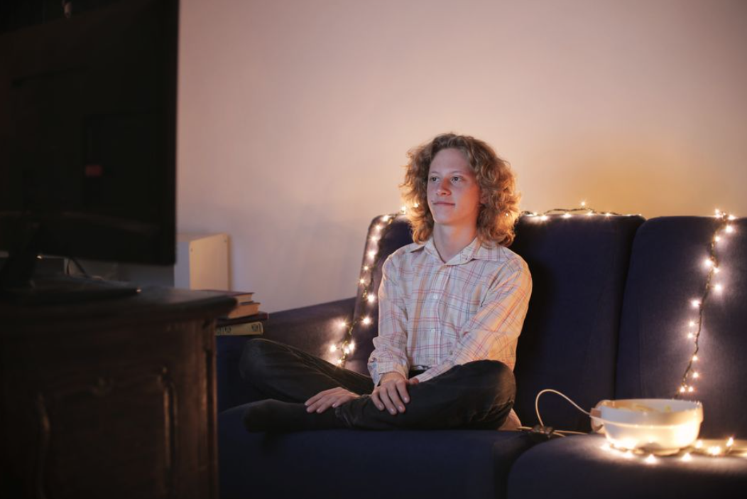 A football fan relaxing at home after a match